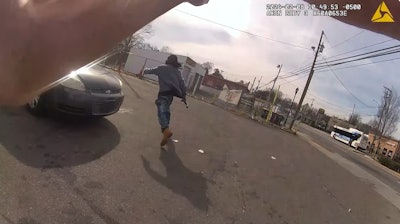 Suspect running from Charlotte-Mecklenburg Police officer with gun in hand. The suspect was shot and wounded by the officer.